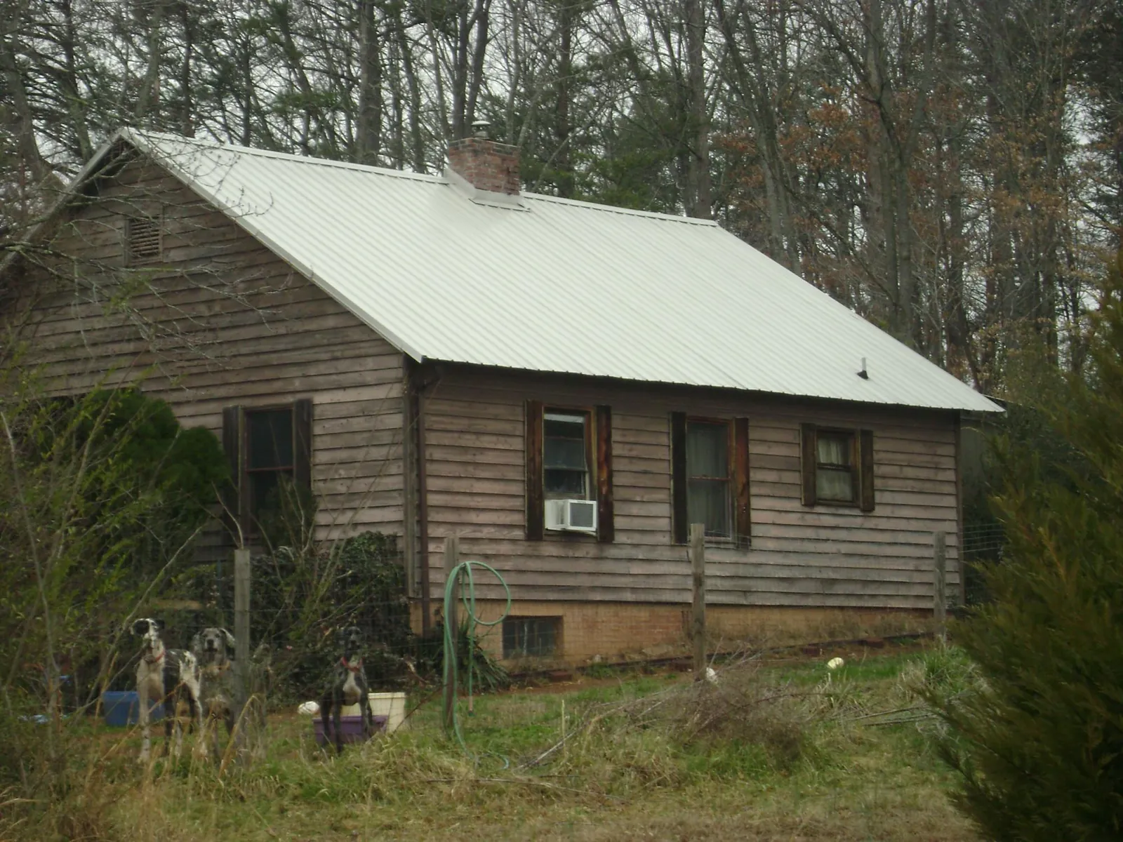 White metal roof on an old wood sided farmhouse, from a Metal Roof Installation job in Hollansburg